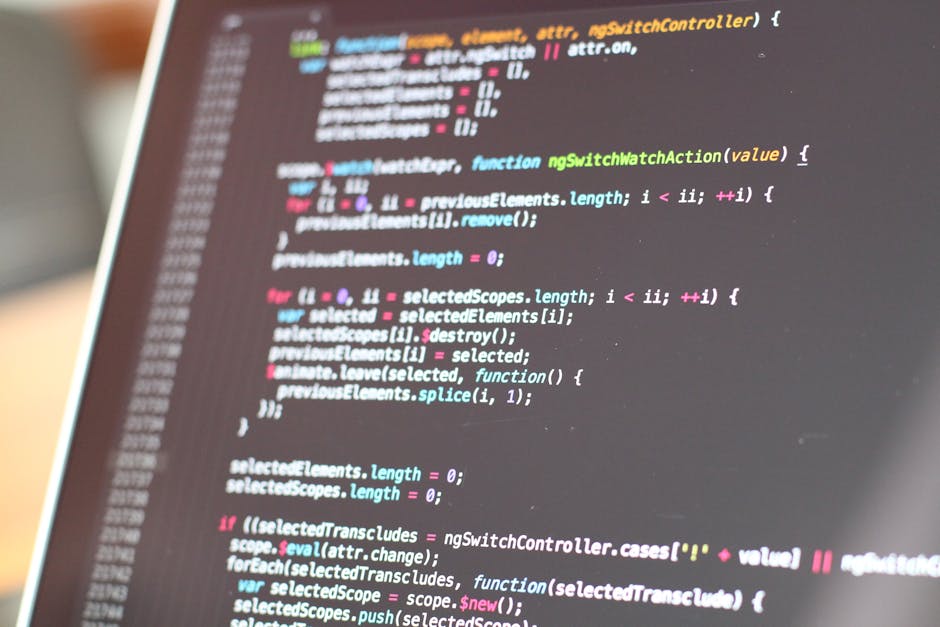 A close-up of a computer screen displaying colorful lines of programming code, with syntax highlighting in shades of pink, blue, green, and white. The code appears to be related to web development or